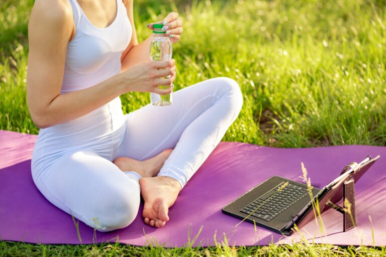Funny woman watching online yoga exercise on laptop. Yoga workshop