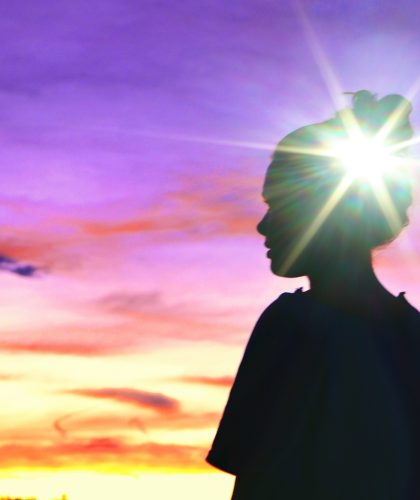 Mental health Female at sunset with bright light on head, healing thoughts hope recovery positive